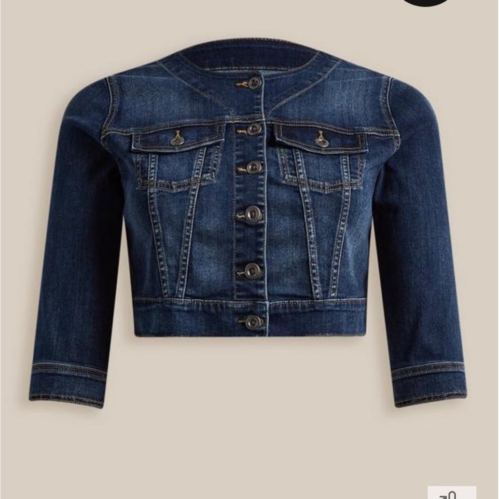 Medium wash crop collarless denim jacket.